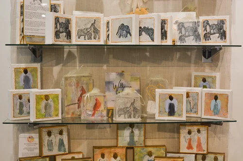 A wall of framed watercolor prints from local makers at Randolph's