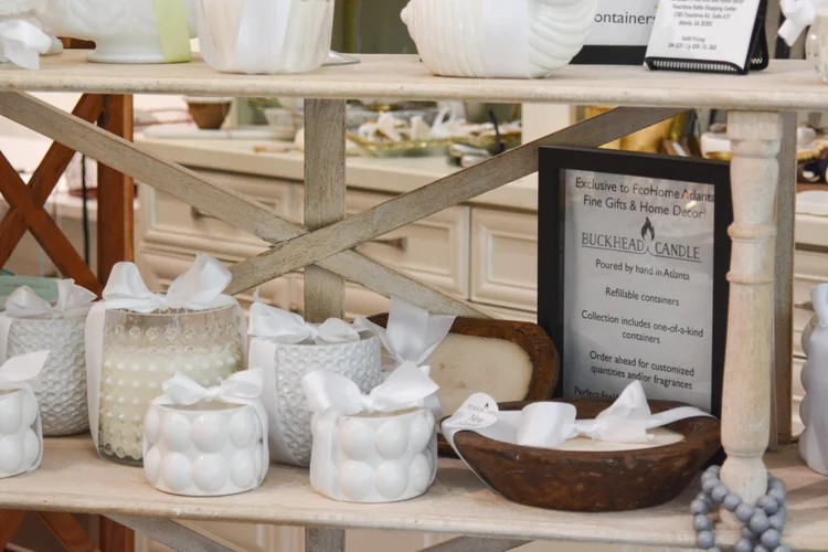 A styled table at Randolph's set with handmade ceramics, a lit candle and dried florals
